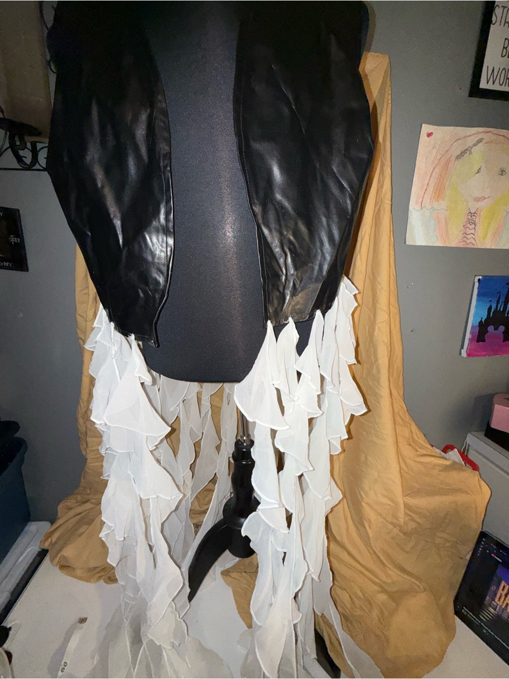 Womenβs Ashley Stewart Black Faux Leather Vest with White Ruffle Trim hanging